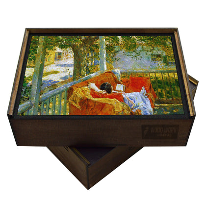 Handcrafted wooden puzzle of Childe Hassam's "Couch on the Porch, Cos Cob."  Impressionist painting of a woman reading on a red couch on a porch.  Summer scene with dappled light. Collectible art puzzle.