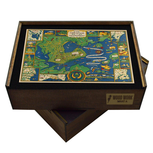 Handcrafted wooden jigsaw puzzle featuring a colorful vintage map of Portland, Maine with illustrations of landmarks, ships, and islands.